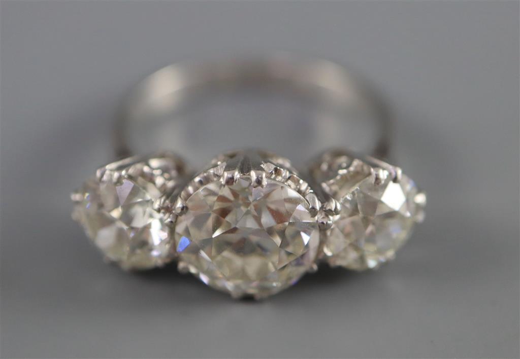 An impressive platinum and three stone diamond ring,